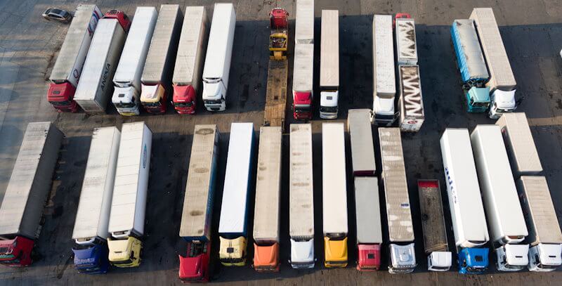 Lorries with trailers parked in warehouse yard